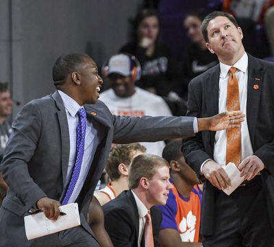 In this February, 2019 photo, Clemson assistant coach Steve Smith, left, gestures as head coach Brad Brownell, right, looks up, during an NCAA college basketball game in Clemson, S.C. Clemson has parted ways Smith on Friday, May 3, 2019, after his voice was heard on a federal wiretap involving defendant Christian Dawkins on the ongoing trial into college corruption. (Ken Ruinard / Independent-Mail via AP)