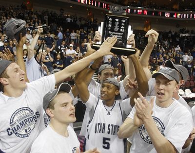 Utah State hoists the WAC tournament trophy after defeating Boise State in the final. (Associated Press)