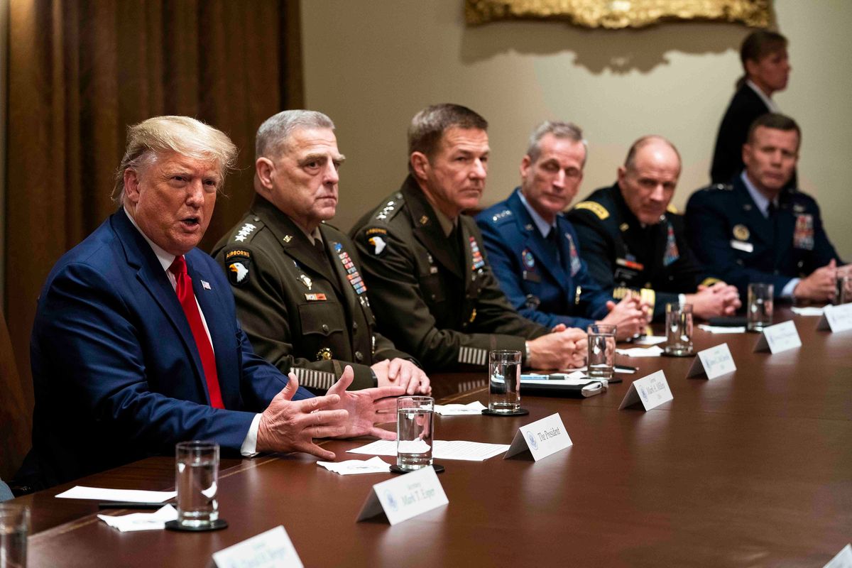 President Donald Trump, left, seated next to Gen. Mark A. Milley, the chairman of the Joint Chiefs of Staff, makes remarks during a briefing with senior military leaders in the Cabinet Room of the White House in Washington, D.C., on Oct. 7, 2019.  (DOUG MILLS)