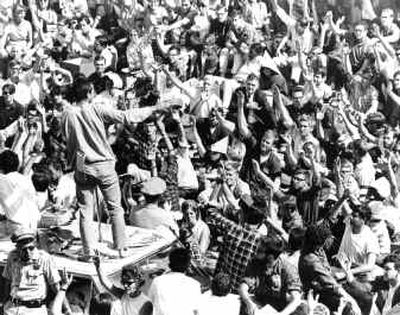 Standing atop the crushed roof of a campus police car, a University of California student asks Cal students to identify themselves during the third day of Free Speech Movement demonstrations at Berkeley, Calif., Oct. 2, 1964.
(File/Associated Press / The Spokesman-Review)
