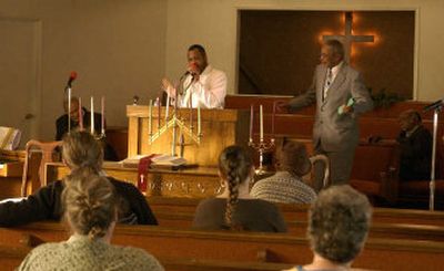 
The Rev. Otis Freelon preaches recently at the St. Matthews Institutional Baptist Church's new location at the Sunset Hill Baptist Church, 2815 W. Sunset Blvd. The group recently began to meet there. The Rev. Eugene Singleton, minister of St. Matthews, joined in the praise. 
 (J. BART RAYNIAK / The Spokesman-Review)