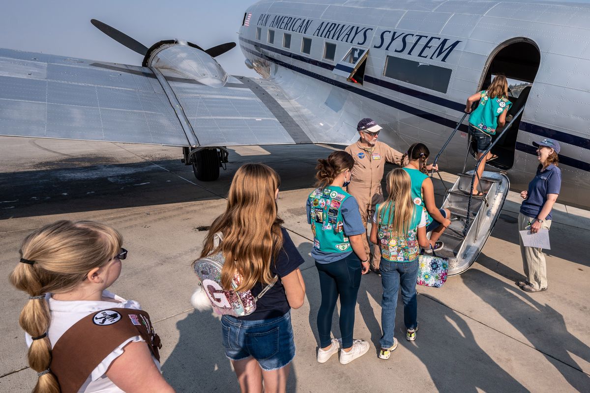 Sixteen local Girl Scouts were treated to a flight over Spokane in a historic World War II era Douglas DC-3 aircraft provided by John Sessions, in flight suit, president of the Historic Flight Foundation, Saturday at Felts Field.  (COLIN MULVANY/THE SPOKESMAN-REVIEW)