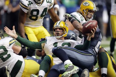 The Packers’ Aaron Rodgers looks for a touchdown call on a quarterback keeper. He got the score after a replay review. (Associated Press / The Spokesman-Review)