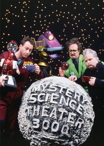 Joel Hodgson and his robot pals stand with mad scientists Clayton Forrester and Frank Conniff in this 1992 file photo taken in Eden Prairie, Minnesota. Hodgson takes TV viewers into his “Mystery Science Theater 3000,” now in its fifth season on Comedy Central. (Associated Press)
