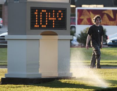 An unidentified pedestrian walks past a time and temperature sign in Lawrence, Kan., on Monday. (Associated Press)