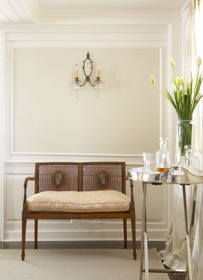 In this room painted with several shades of white, a warmer white on the wall inset punctuates the classic trim detail and adds to the formal feel of the space. (Associated Press)