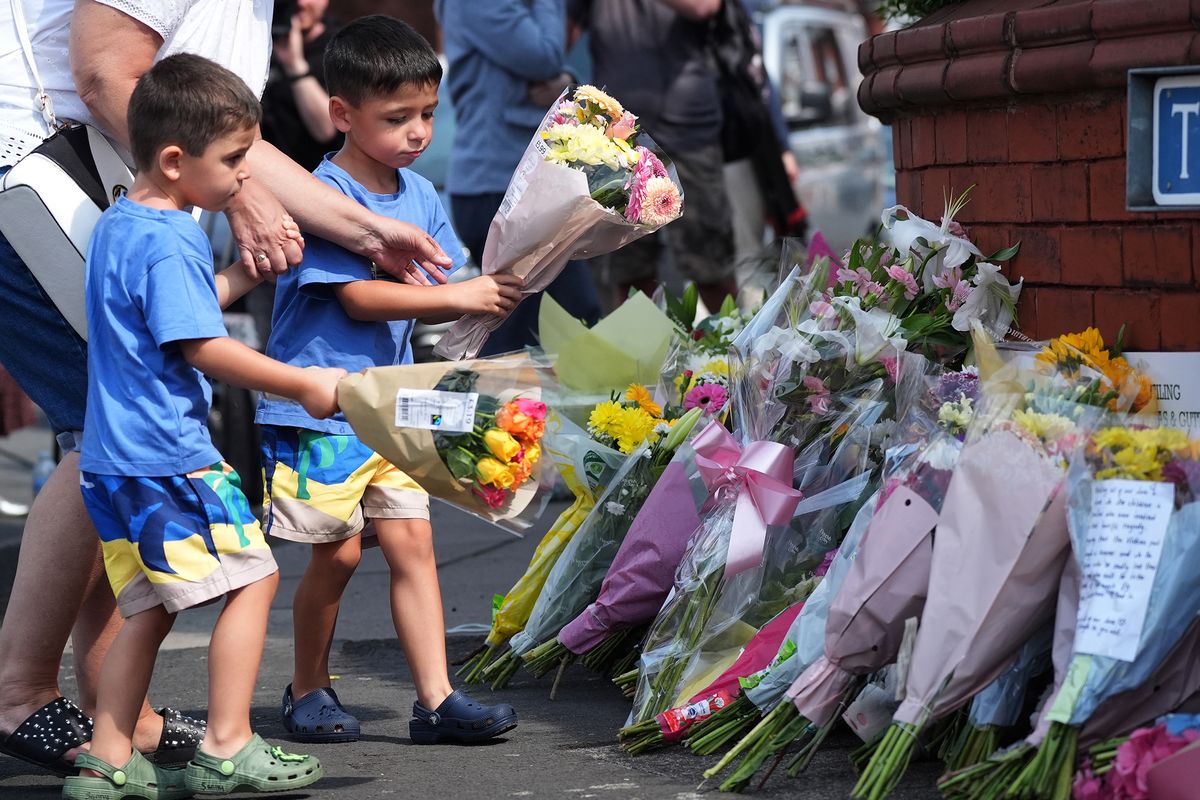 Tributes to the victims are left by well-wishers on Tuesday in Southport, England. A teenager armed with a knife attacked children at a Taylor Swift-themed holiday club Monday morning.  (Christopher Furlong)