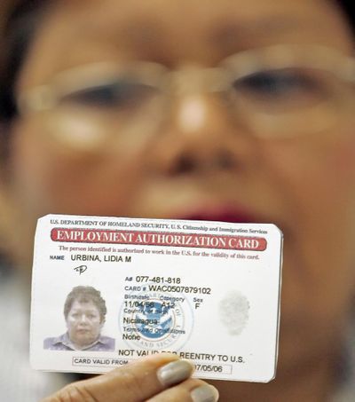 Lidia M. Urbina, of Nicaragua, shows a copy of her work permit Thursday, Jan. 26, 2006, in Miami. (ALAN DIAZ / Associated Press)