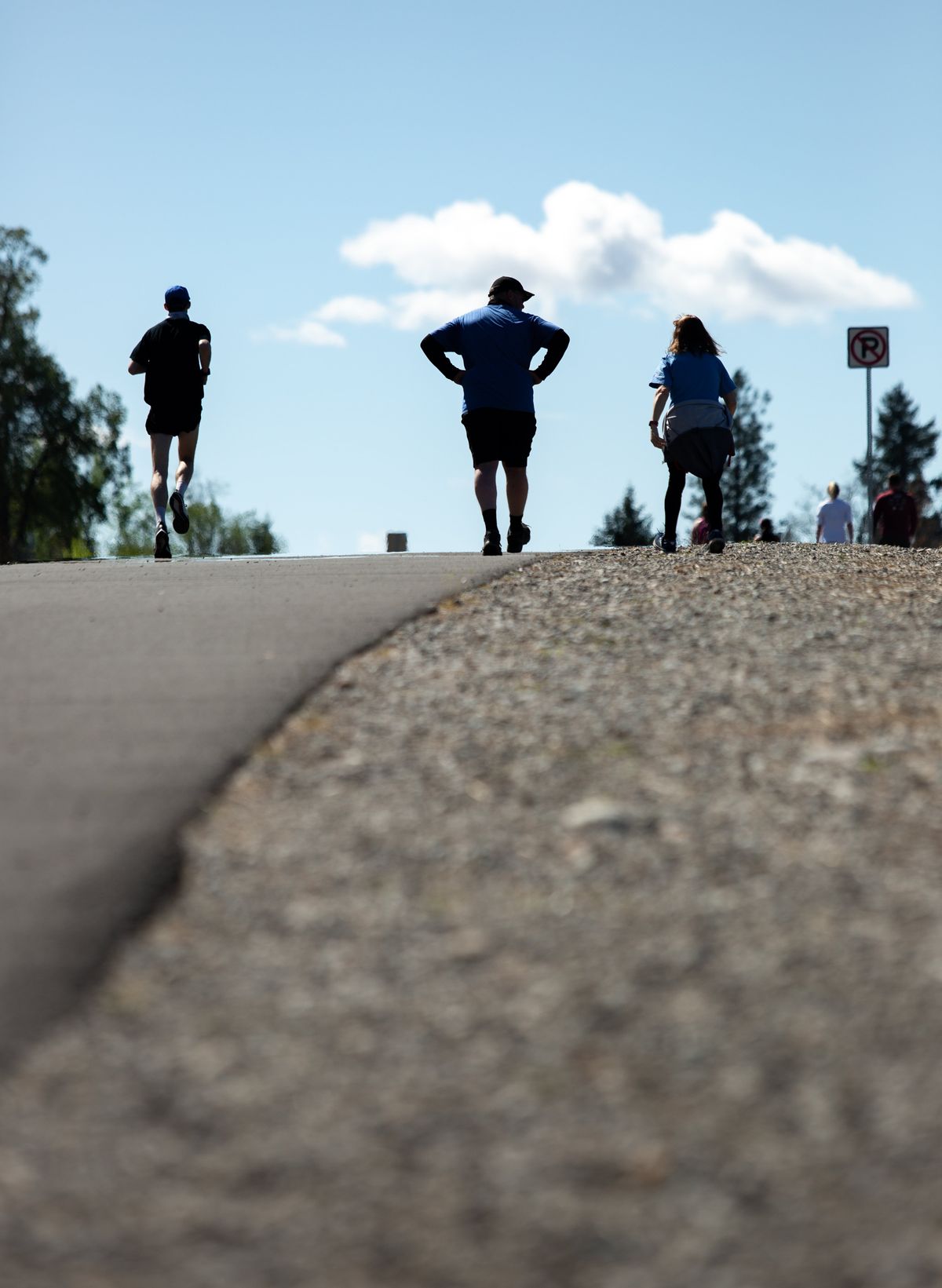 Runners reach the top of “Doomsday Hill” Sunday on Pettet Drive during Virtual Bloomsday in Spokane.  (Libby Kamrowski/ THE SPOKESMAN-R)
