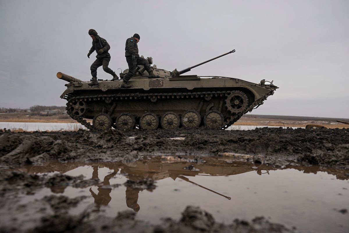 Ukrainian servicemen walk on an armored fighting vehicle during an exercise in a Joint Forces Operation controlled area in the Donetsk region, eastern Ukraine, Thursday, Feb. 10, 2022. A peace agreement for the separatist conflict in eastern Ukraine that has never quite ended is back in the spotlight amid a Russian military buildup near the country