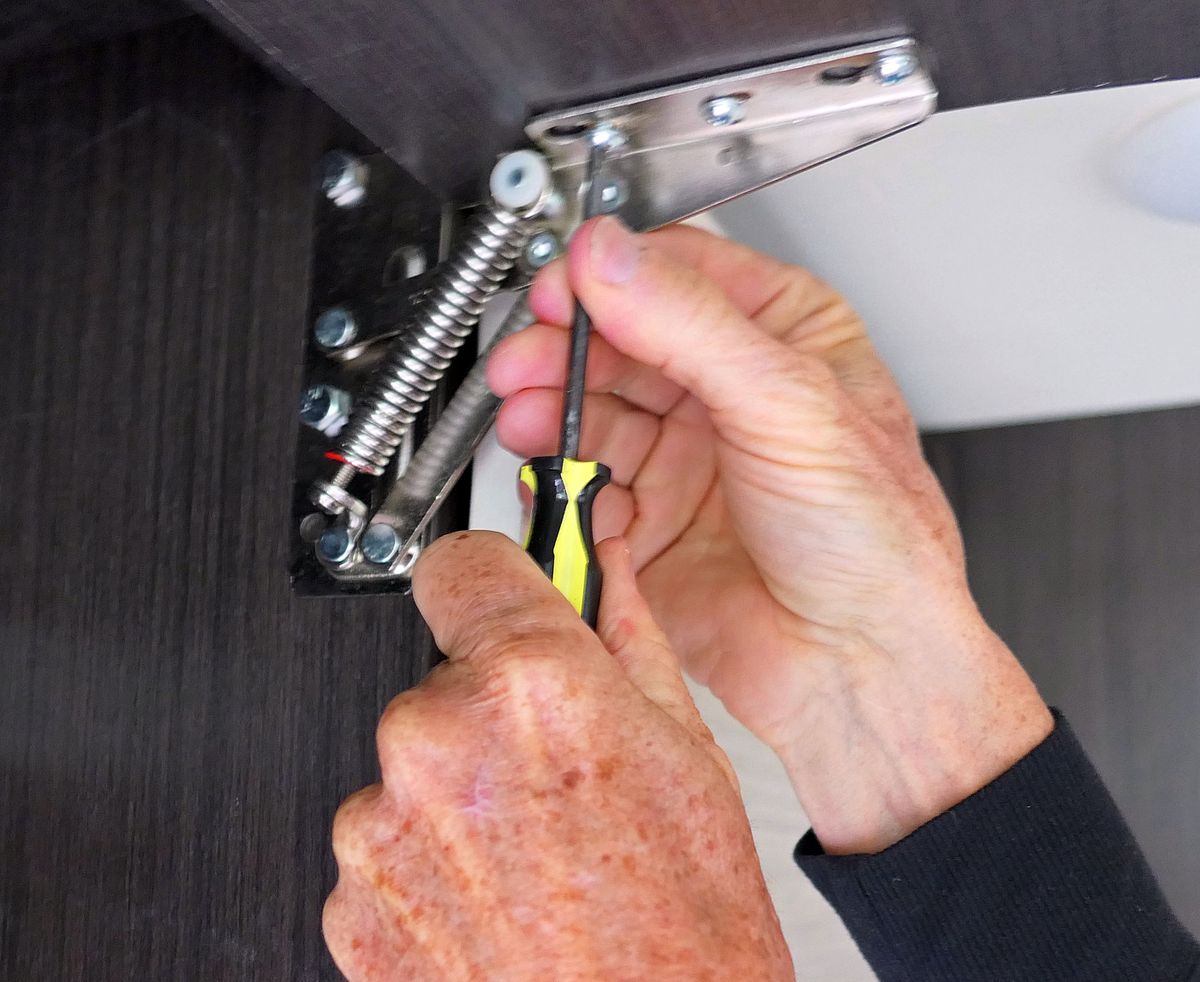 Use your downtime to tighten the screws on cabinets which inevitably become loose during highway driving. (Leslie Kelly)