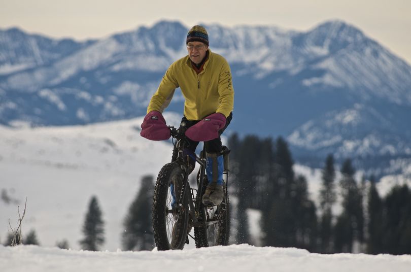 Steve Mitchell, owner of Rocking Horse Bakery in Winthrop and a volunteer trail groomer, rides his fat bike in Pearrygin State Park with the Methow Valley's Gardner Mountain in the background. (Steve Mitchell )