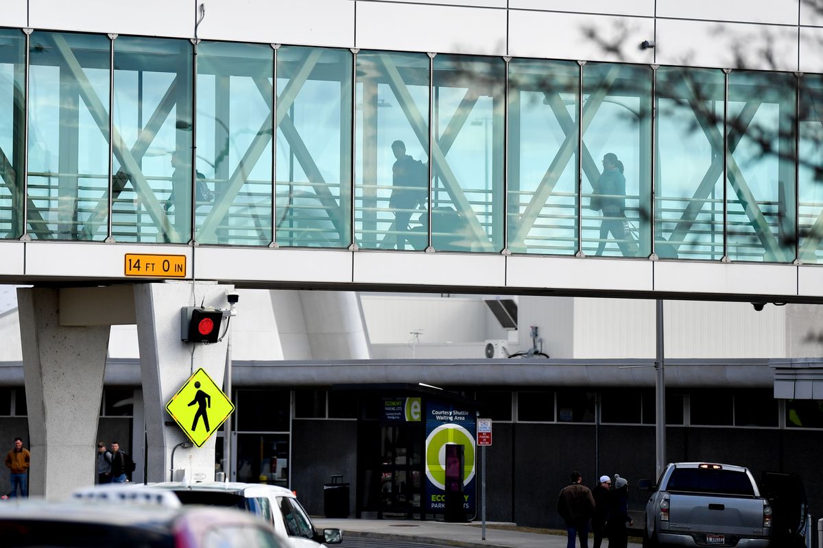Travelers pass through a skybridge on March 1, 2020, at Spokane International Airport. Traffic at the airport would decrease in the coming months as the coronavirus pandemic took hold. Indications nationally show air travel is poised for a big comeback this summer.  (TYLER TJOMSLAND/The Spokesman-Review)