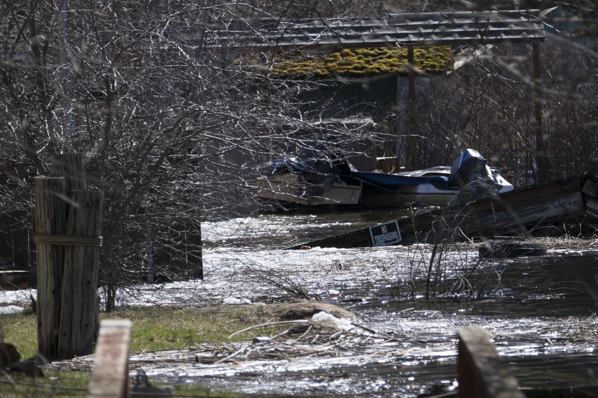The waterfront vacation homes on the  shore of Williams Lake are surrounded by some of the debris washed in by the high water and the damage to docks and landscaping by  cresting floodwaters. Sunday, Mar. 19, 2017. Jesse Tinsley/THE SPOKESMAN-REVIEW (Jesse Tinsley / The Spokesman-Review)