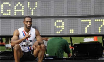 
Tyson Gay sits next to a time clock showing his U.S. record in 100. Associated Press
 (Associated Press / The Spokesman-Review)