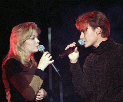 LeAnn Rimes joins Bryan White onstage at Disneyland in Anaheim, California, on Dec. 1, 1997, for a duet during their 