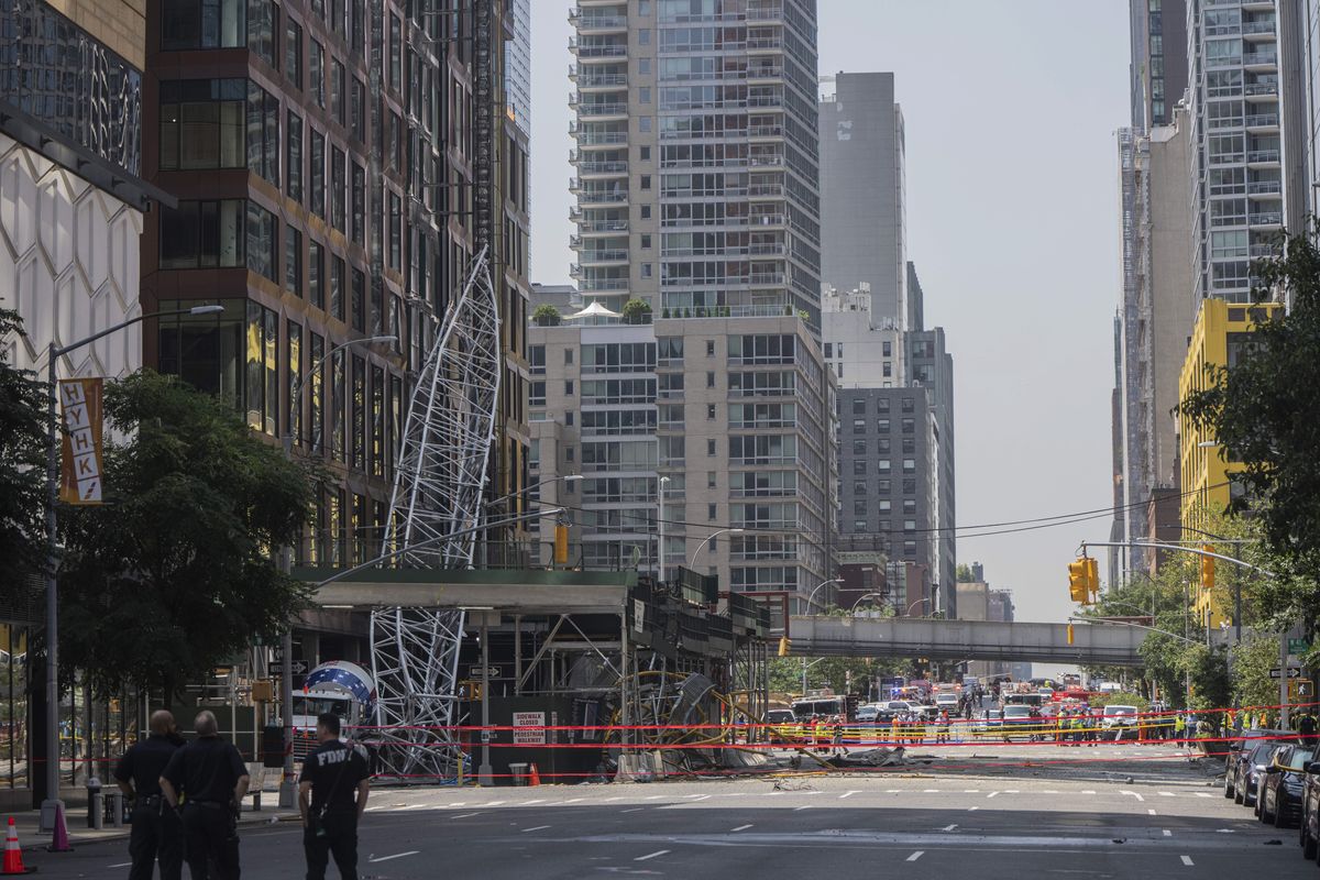 Debris that fell from a tower crane that caught fire and partially collapsed 45 stories above the street at 550 10th Avenue in New York, July 26, 2023. Four civilians and two firefighters received minor injuries when the crane on 10th Avenue collapsed, officials said.    (Hiroko Masuike/The New York Times)