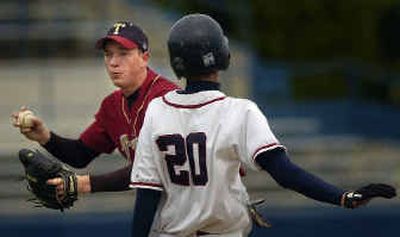 
University's Adam Smith can't make the double play and lets Mt. Spokane's Paul Smith advance to second before making the out at first base. 
 (Jed Conklin / The Spokesman-Review)