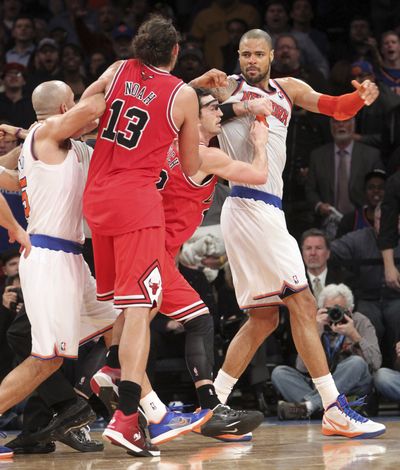 New York’s Jason Kidd, left, and Chicago’s Kirk Hinrich, second from right, separate Joakim Noah and Tyson Chandler on Friday. (Associated Press)