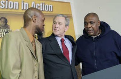 President Bush puts his arms around Adolphus Mosely, left, and Tom Boyd,  two recent graduates of the Jericho Program, during his visit and tour of the center Tuesday in Baltimore. 
 (Associated Press / The Spokesman-Review)