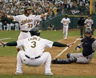 
A's Nick Swisher  celebrates after he scored on a double by Marco Scutaro in the seventh inning.
 (Associated Press / The Spokesman-Review)
