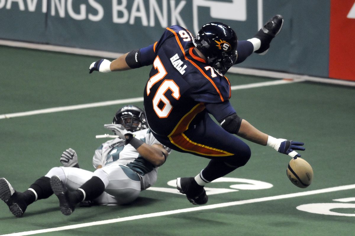 Branden Hall of the Spokane Shock recovers his fumble after a reception and getting hit by Bossier-Shreveport's PJ Berry in the first quarter Saturday, April 17, 2010, in the Spokane Arena. (Dan Pelle / The Spokesman-Review)