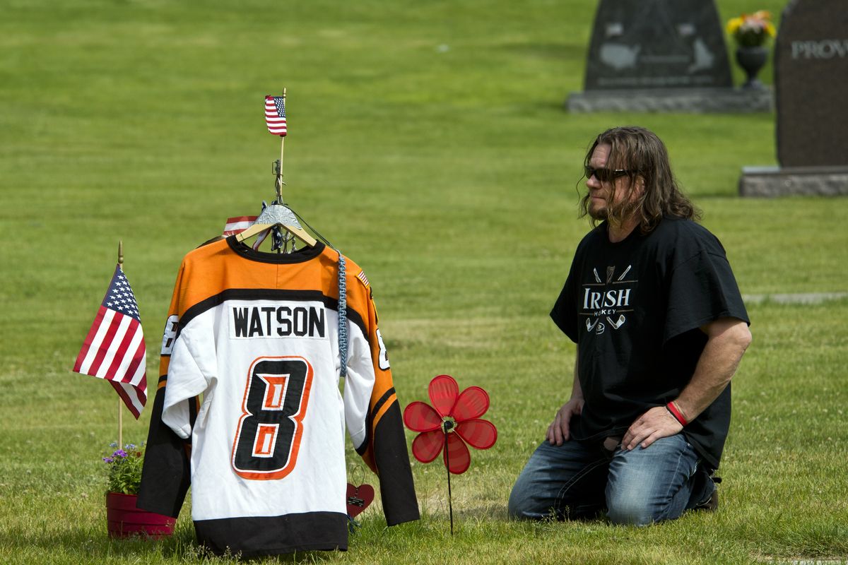 Todd Watson visits the gravesite of his son, Cody, on June 12 at Holy Cross Cemetery in Spokane. The family placed Cody’s hockey jersey at the site until a gravestone was ready, but the jersey was stolen a few days later. (Dan Pelle)
