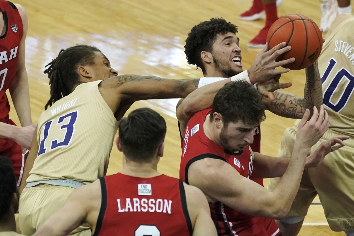 Washington forward Hameir Wright (13) and Utah forward Timmy Allen upper right, battle for the ball during the first half of an NCAA college basketball game, Sunday, Jan. 24, 2021, in Seattle.  (Ted S. Warren)