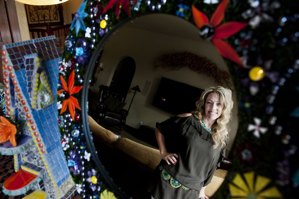 Amy Galbavy poses for a portrait with some of her glass art Aug. 26, at her home in Spokane. (Tyler Tjomsland)