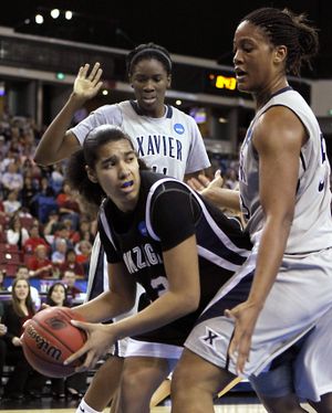 Gonzaga's Vivian Frieson, center, is double teamed by Xavier's Amber Harris, background and Ta'Shia Phillips right, during the first half of an NCAA Sacramento Regional semifinal college basketball game in Sacramento, Calif., Saturday, March 27, 2010. (Rich Pedroncelli / Associated Press)