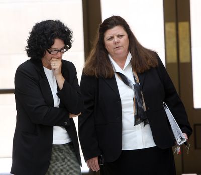 Democrat Julie Kane, left, and Republican Lorna Finman of Idaho’s bipartisan citizen redistricting commission confer outside of the Idaho Statehouse auditorium during negotiations on Tuesday. (Joe Jaszewski)