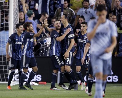 LA Galaxy forward Zlatan Ibrahimovic (9) celebrates with teammates after scoring a goal during the second half of an MLS soccer match against the Sporting Kansas City Wednesday, May 29, 2019, in Kansas City, Kan. LA Galaxy won 2-0. (Charlie Riedel / Associated Press)
