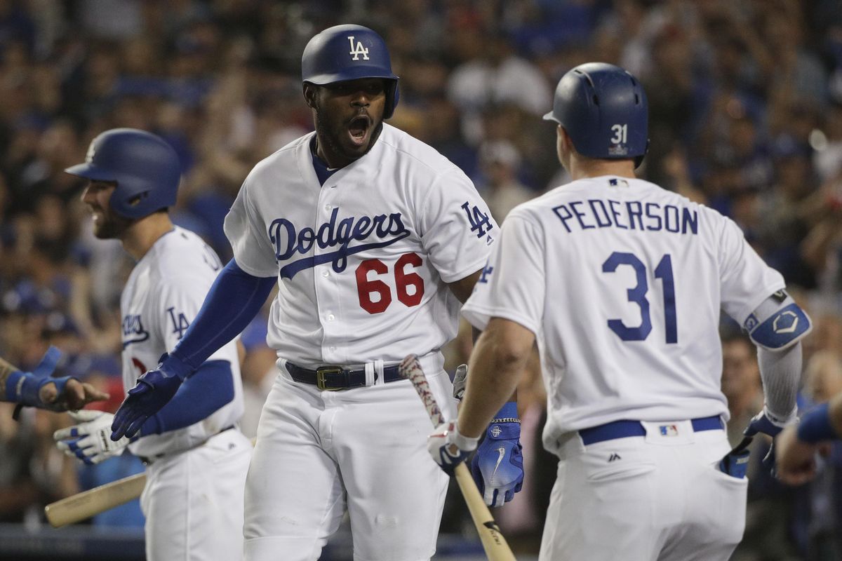 Los Angeles Dodgers’ Yasiel Puig  celebrates after his three-run home run against the Boston Red Sox during the sixth inning in Game 4 of the World Series on Saturday in Los Angeles. (Jae C. Hong / AP)