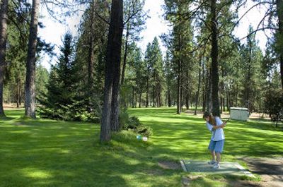 The Spokesman-Review Pine Acres  is aptly named. Here, Cecilia Holland tees off in the shade on a 100-degree day last month.
 (Christopher Anderson / The Spokesman-Review)