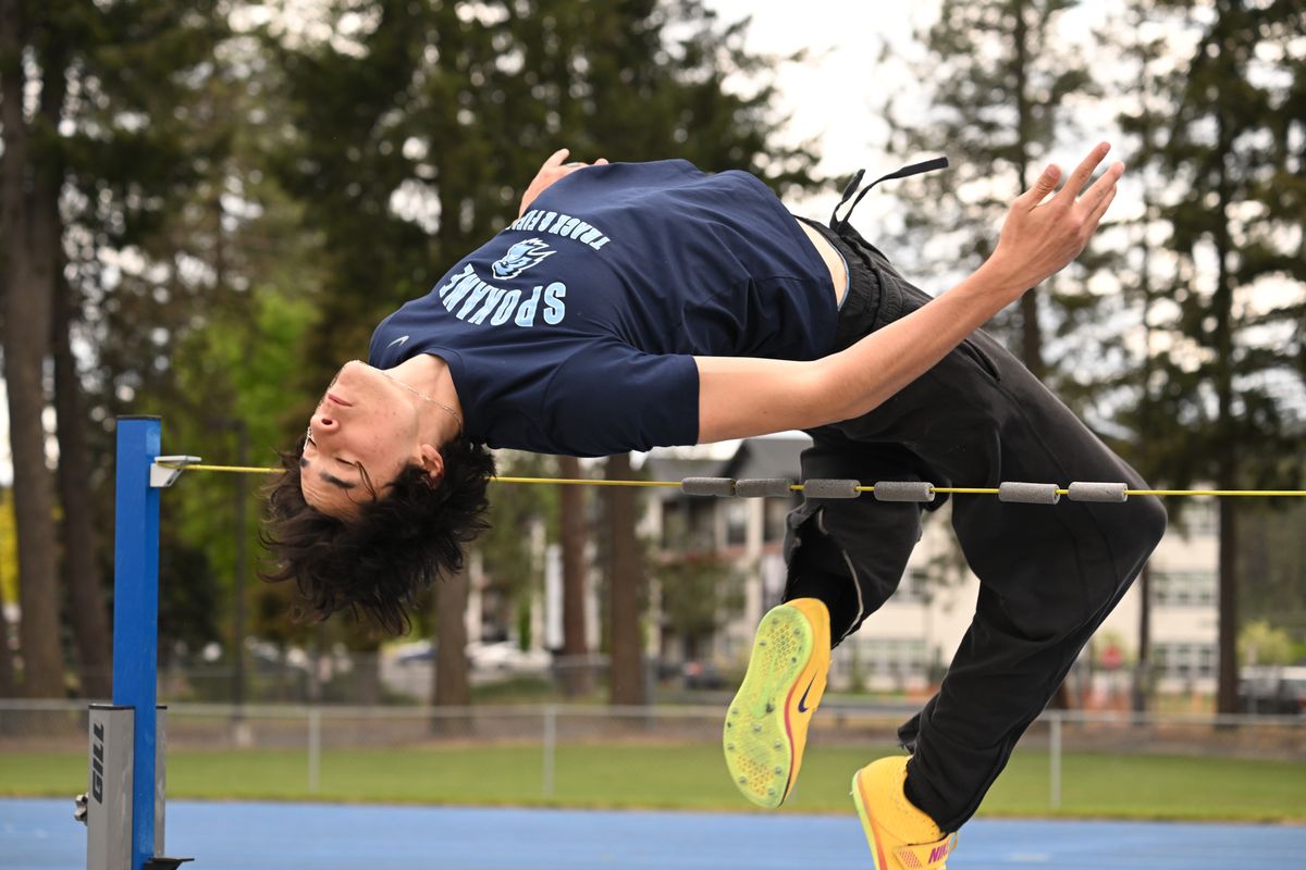 Napela Naihe, a track athlete for Spokane Colleges, warms up for the high jump using a bunjee chord on Thursday at Spokane Falls Community College. (Jesse Tinsley/THE SPOKESMAN-REVI)