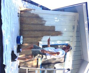 Earlier this week, Will Meyer of Lakeside House Inspections scrapes and paints a bump-out windown above the porch at Casa Oliveria. (Mrs. O photo for Huckleberries)