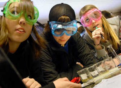 
North Central High School sophomores from left, Elyse Maurer, Adam Hoffman and Amy Kragt work on an science experiment on Thursday. 
 (Brian Plonka / The Spokesman-Review)