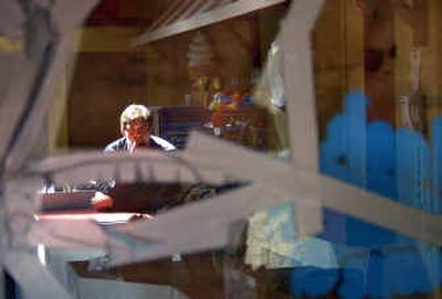 
Owner Geoff Kellogg is reflected in the broken window in the gift shop at Splash-Down in the Spokane Valley on Monday. Splash-Down was vandalized Friday night. He hasn't decided whether to press charges against the arrested teenagers.
 (Liz Kishimoto / The Spokesman-Review)