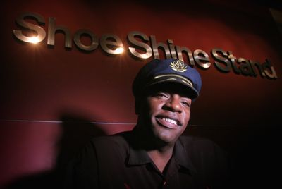 Leon McLaughlin sits at his shoeshine stand on the second floor of the Columbia Tower in Seattle last month. McLaughlin set out to find a water-filtration machine, then founded his one-man company, LAM, to bring the machine to developing countries. Associated Press/Seattle Times, Ellen M. Banner (Associated Press/Seattle Times, Ellen M. Banner / The Spokesman-Review)