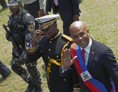 President Michel Martelly, right, walks with Chief of Police Mario Andresol during Haiti’s inaugural ceremony in Port-au-Prince. (Associated Press)