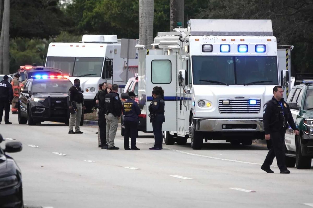 Law enforcement gather near the scene of a shooting that wounded several FBI agents in Sunrise, Fla., Tuesday, Feb. 2, 2021.  (Joe Cavaretta)