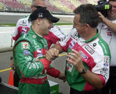 
Tony Kanaan of Brazil is congratulated by his crew after capturing the pole position during a qualifying run for the IRL Michigan Indy 400.  
 (Associated Press / The Spokesman-Review)