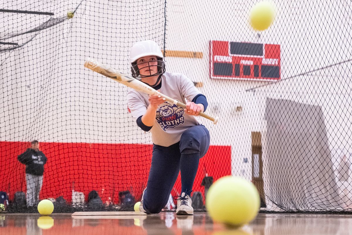 Senior infielder Donyelle Strauss lays down a bunt during an indoor practice session at Ferris High School. (Madison McCord/The Spokesman-Review)