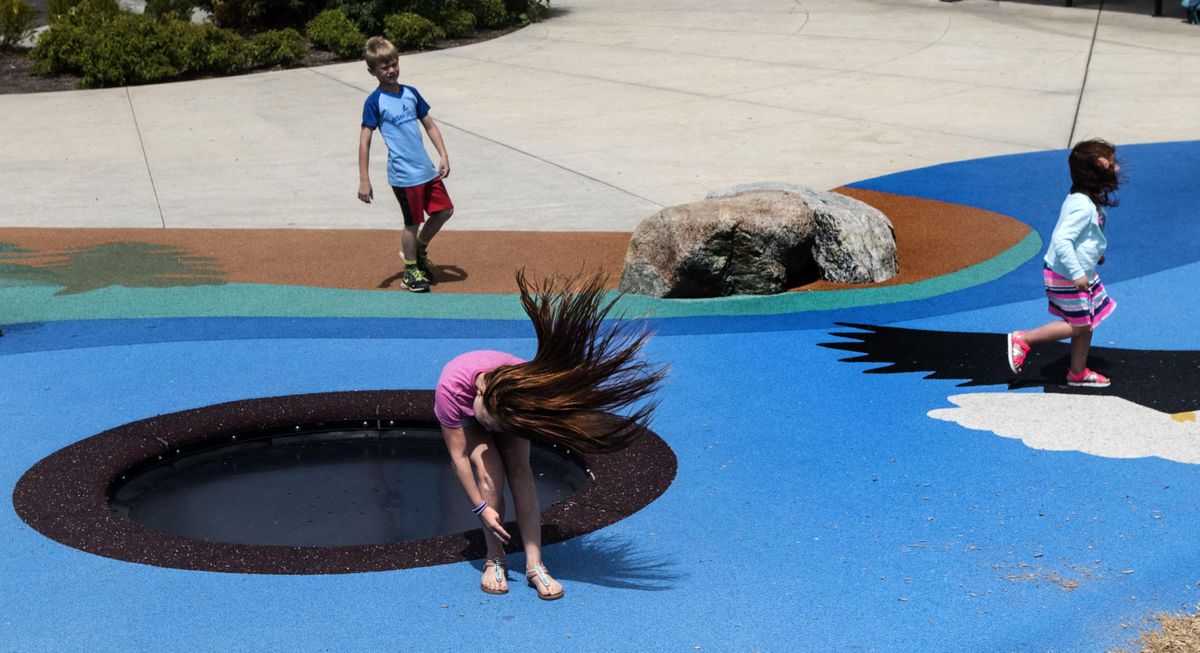 Mercedes Martin, 9, jumps off  the inground trampoline at Discovery Playground in Spokane Valley on Wednesday, June 13. (Kathy Plonka / The Spokesman-Review)