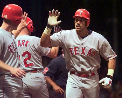 In this Aug. 31, 1998 photo, Texas Rangers’ Juan Gonzalez, right, is congratulated after his two-run homer in Detroit. On April 19, 1996, Gonzalez homered and drove in six runs as Texas beat Baltimore 26-7. (Duane Burleson / Associated Press)