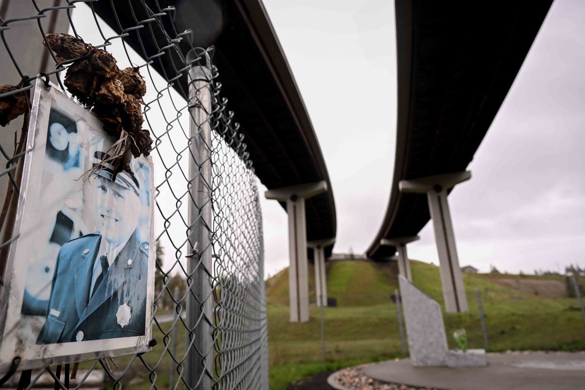 An image of Lieutenant Cody Traber, who served 18 years with Spokane County Fire District 9 before falling to his death responding to a wildland fire in August 2021, is photographed at a memorial site under the U.S. Highway 395 bridge over Wandermere Road on Wednesday at 13480 N. Wandermere Road, in Spokane. The Washington Transportation Commission voted Wednesday to rename the bridge in honor of Traber. (Tyler Tjomsland/The Spokesman-Review)