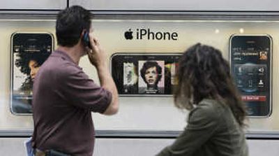 Pedestrians check out the window display advertising Apple Inc.'s new iPhone, last week in Chicago. The new phone can handle phone calls, e-mail, Web browsing, music and videos.Associated Press
(Associated Press / The Spokesman-Review)