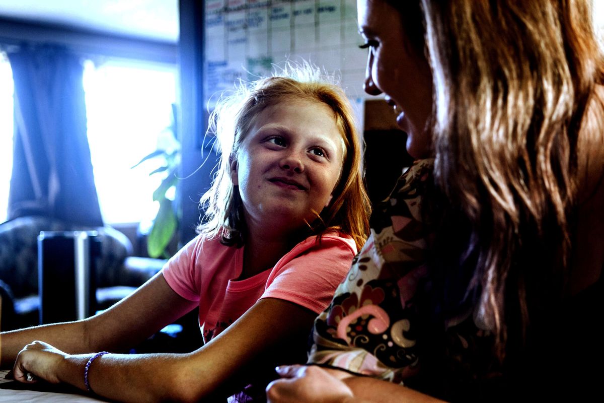 Ten-year-old Madisyn Connor gets some homework help from her mother, Heather Cantamessa, at their home in Spokane on Sept. 5.
