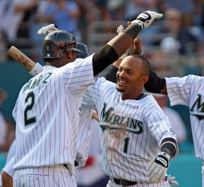 Florida’s Hanley Ramirez, left, greets Emilio Bonifacio at home after the inside-the-park homer by Bonifacio. (Associated Press / The Spokesman-Review)