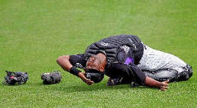 
Colorado catcher Charles Johnson stretches prior to a spring training game Saturday. Johnson hasn't slacked off even though he knows he doesn't figure in the Rockies' plans. 
 (Associated Press / The Spokesman-Review)
